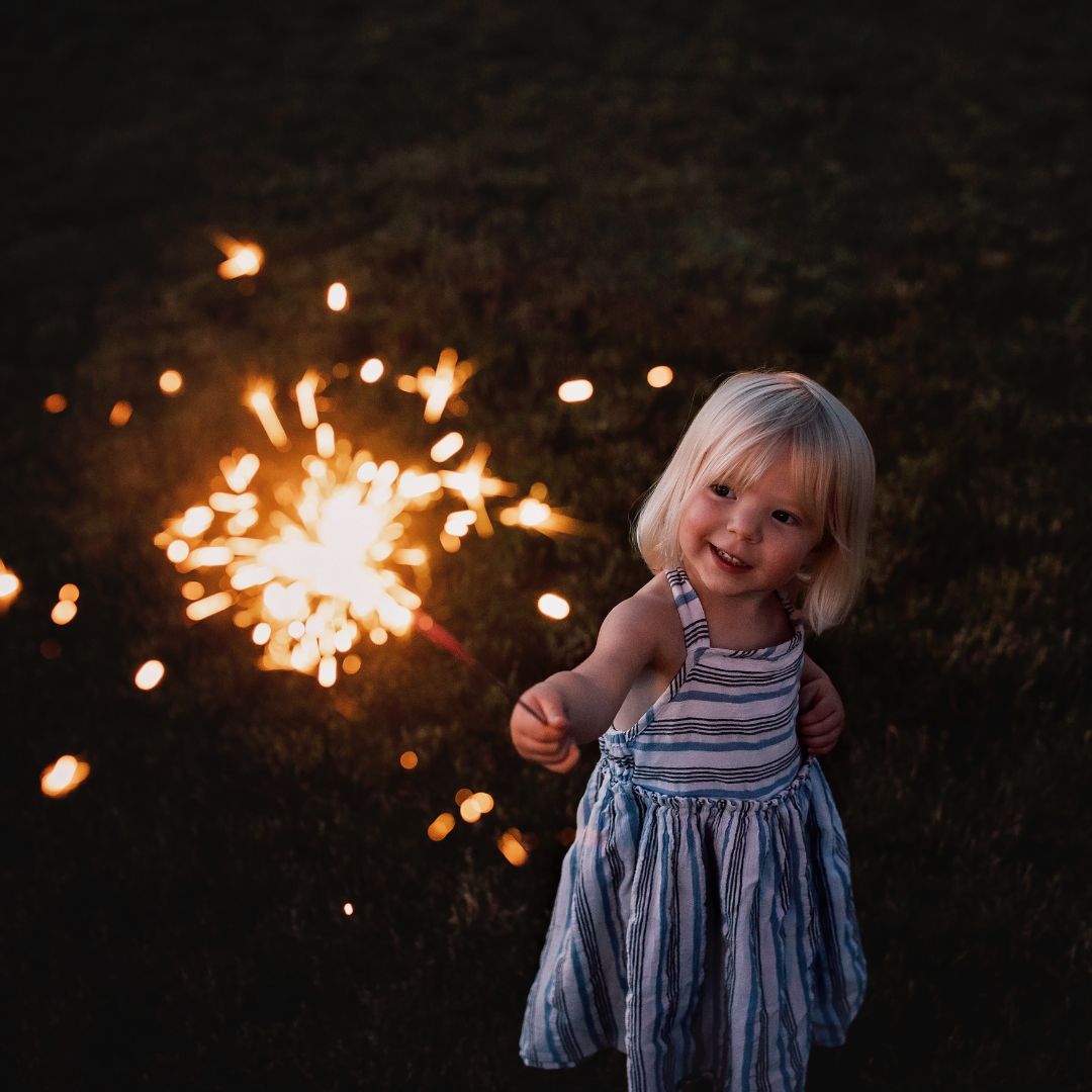 Small girl holding a sparkler